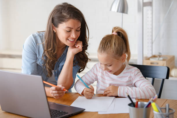 istock Mother and daughter learning together at home, in front of a computer 1822722888