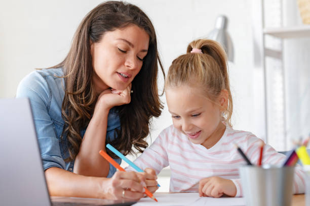 istock Mother and daughter learning together at home, in front of a computer 1822728359