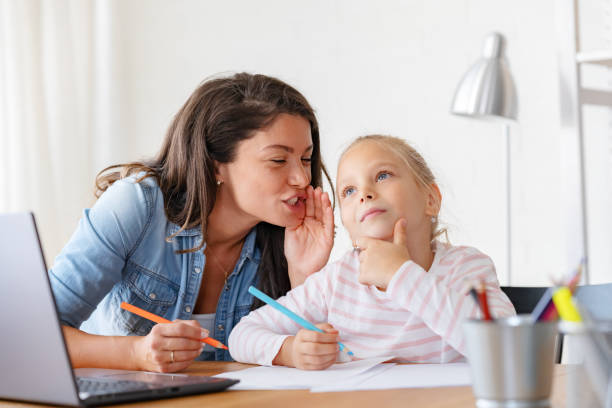 istock Mother and daughter learning together at home, in front of a computer 1822731000