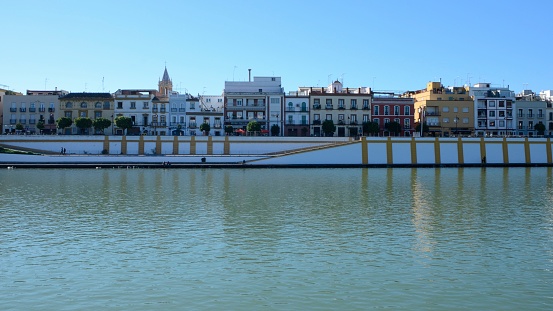 Seville, Spain - November 25, 2023: People at Triana bridge over the river Guadalquivir in Seville, Spain.