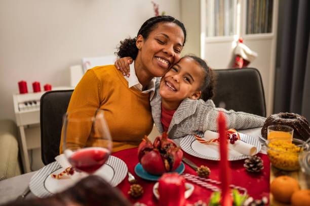 istock Mother bonding with her daughter on a Christmas Eve dinner. 1822734855