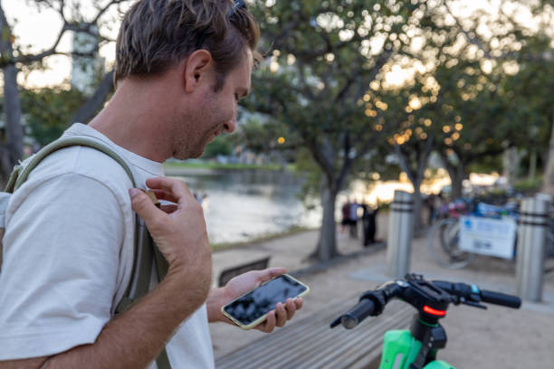 istock Young man renting an electric scooter using a mobile app 1822741459
