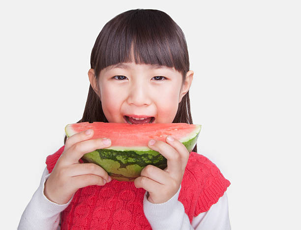 istock Little Girl eating watermelon, studio shot 182274585
