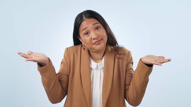 Choice, shrug and face of woman in a studio with mockup for advertising, promotion or marketing. Doubt, decision and portrait of Asian female model with comparison hand gesture by white background.