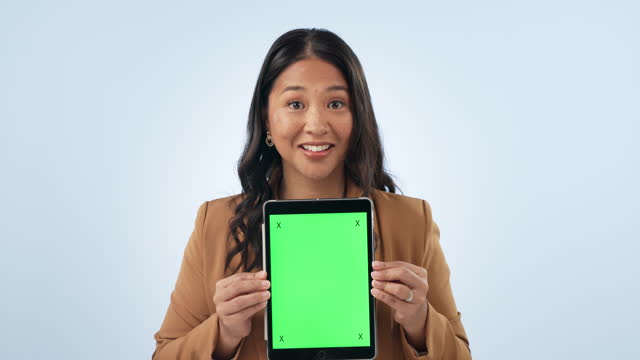 Professional woman, tablet green screen and presentation, website space, business information or advertising in studio. Face of Asian employee, digital mockup and tracking marker on a blue background