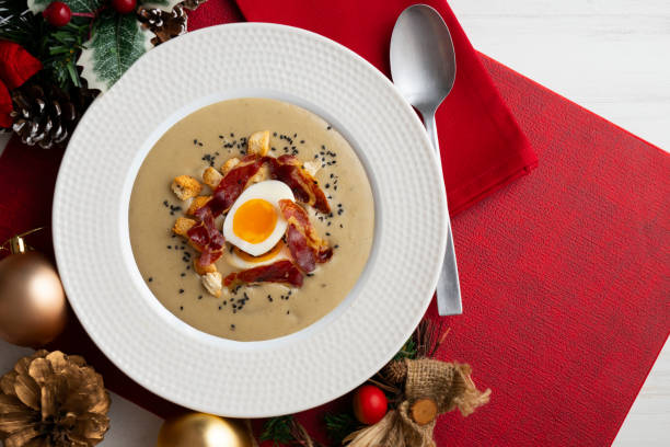 Smoked aubergine cream with crispy Iberian ham and boiled egg.