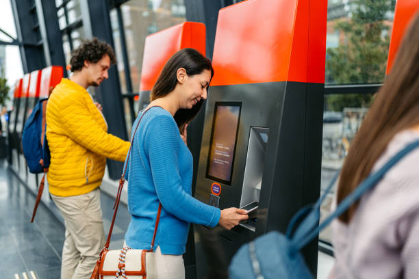 istock Young Woman Buying Train Ticket Using Her Smartphone At The Train Station In Malmo 1822755067