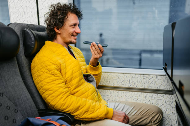 adult man sending a voice message while riding the train in malmo - vocoder imagens e fotografias de stock