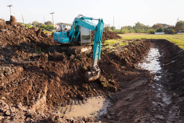 istock excavator backhoe working in the digging a soil to adjust the postharvest areas in the rice fields. agriculture machinery for modern agriculture industry. 1822761742