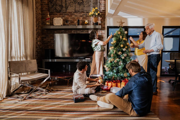 istock Family decorating the christmas tree at home 1822765702