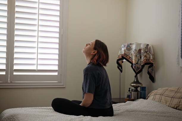 istock Woman sits on bed and looks up 1822765719