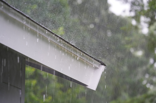Heavy rain falling on the roof in summer