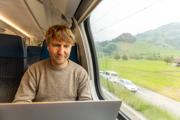 istock Young man working on a laptop while traveling by train 1822769418