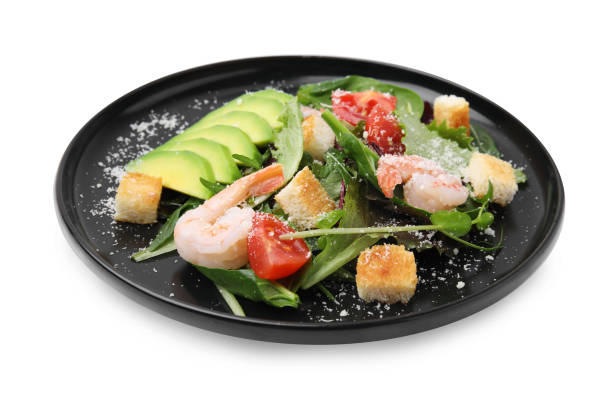 istock Delicious salad with croutons, avocado and shrimp isolated on white 1822778021