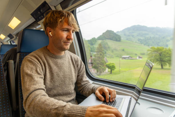 istock Young man working on a laptop while traveling by train 1822778569