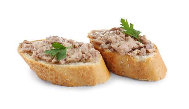 istock Tasty sandwiches with cod liver and fresh parsley isolated on white 1822778603