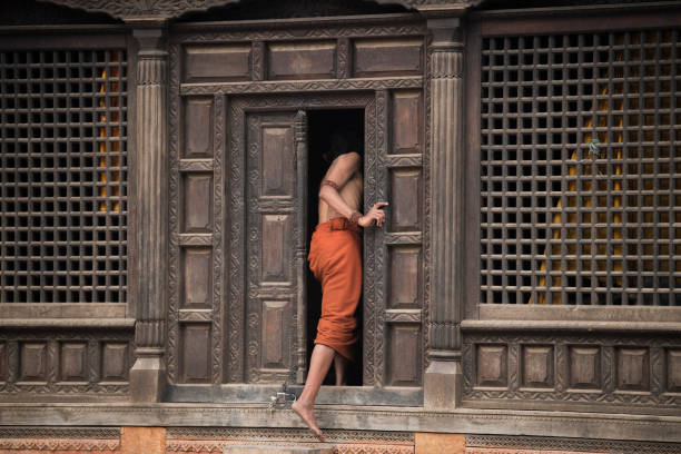 Kathmandu, Nepal- April 20,2019 : Sadhu-Indian Holy man sitting in the temple. In Hinduism, Sadhu is a common term for a mystic, an ascetic, practitioner of yoga.