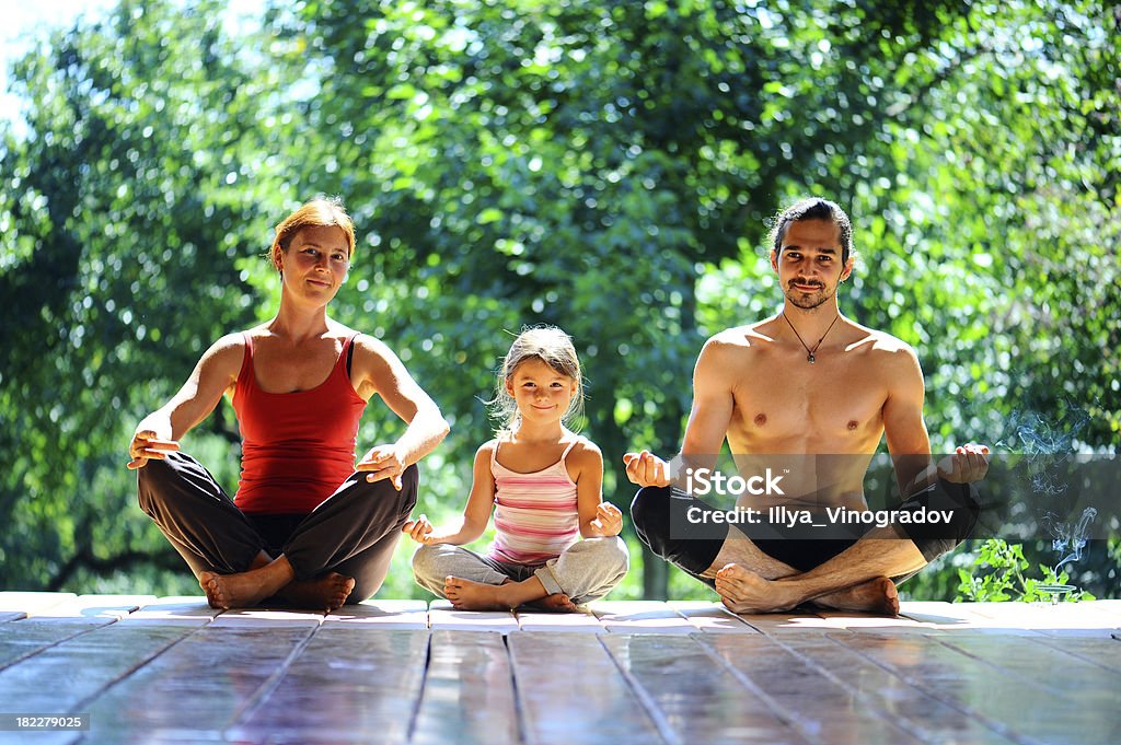 young family meditates Activity Stock Photo