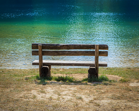Old wooden bench in the park by the lake