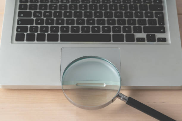 istock Magnifying glass and laptop 1822805662