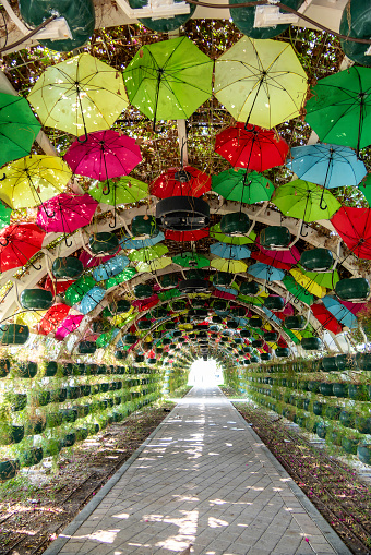 Doha, Qatar, October 31, 2023. Green tunnel and umbrellas for shade at Corniche metro station.