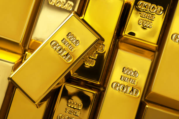 istock Many shiny gold bars as background, top view 1822827384