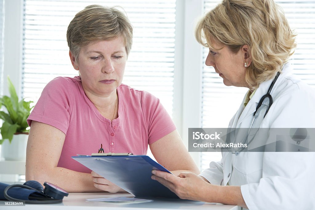 Doctor and patient physician discusses test results with her female patient Adult Stock Photo