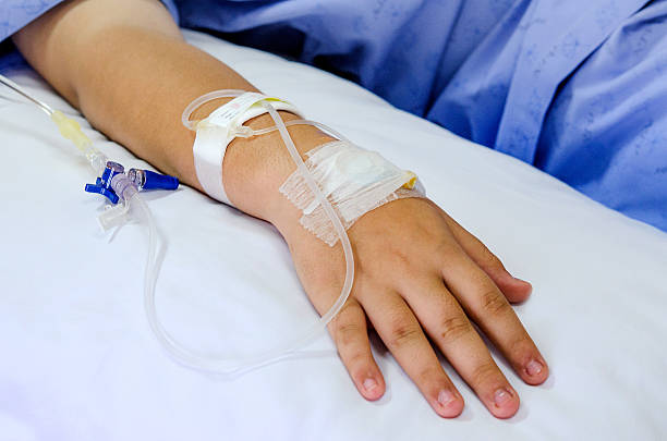 IV solution in patient hand stock photo