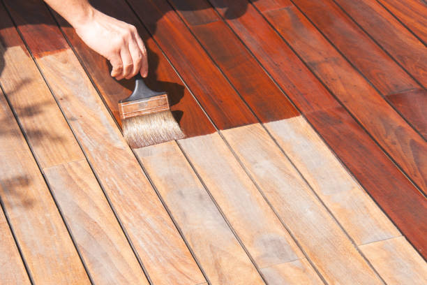 istock Oiling wooden terrace with a brush, wood deck staining 1822836337