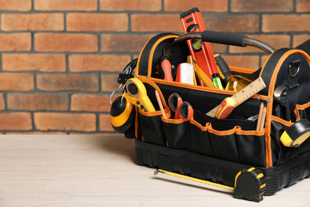 istock Bag with different tools for repair on white wooden table near brick wall. Space for text 1822836566