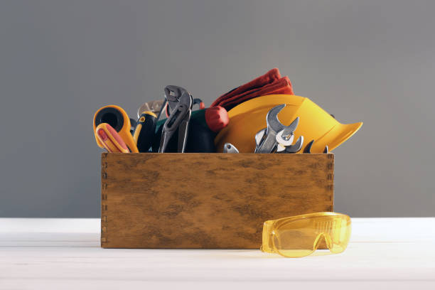 istock Wooden box with different tools for repair and protective glasses on white table 1822836603