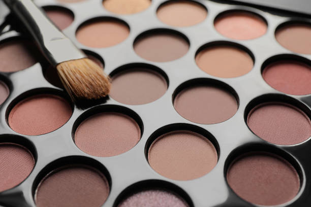 istock Beautiful eye shadow palette with brush, closeup 1822836648