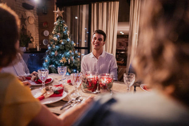 istock Young man talking with his family at Christmas dinner 1822837286