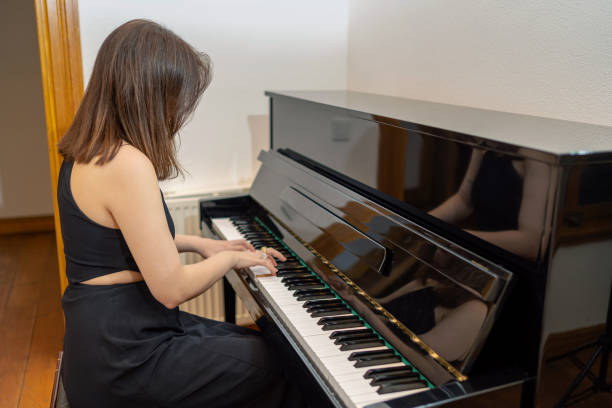 istock Young woman playing the piano 1822847378