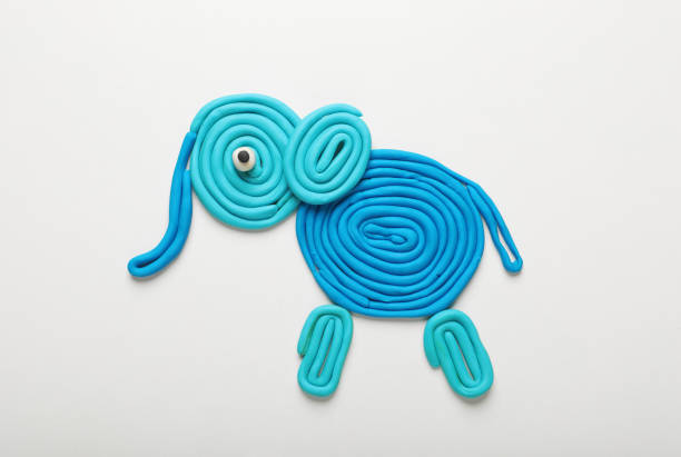 Light blue plasticine elephant isolated on white, top view