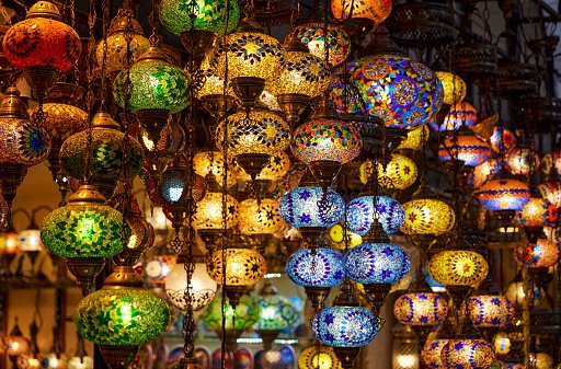 A store window showcasing a collection of vibrant, multi-colored chandelier lights in Grand Bazar in Istanbul