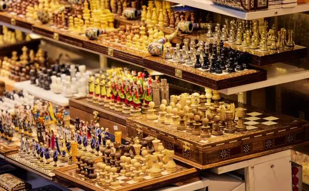 A selection of chess pieces are displayed together on shelves in Grand Bazar in Istanbul, Turkey