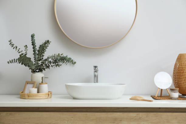 istock Stylish mirror, eucalyptus branches and vessel sink in modern bathroom. Interior design 1822869602