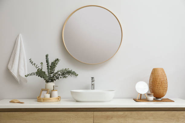 istock Stylish mirror, eucalyptus branches and vessel sink in modern bathroom. Interior design 1822870084