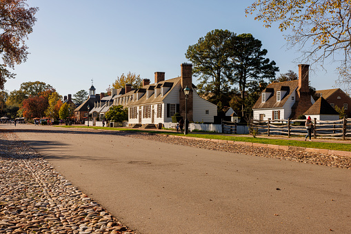 Colonial Williamsburg, Virginia, USA — October, 2023: Merchants Square and Resort Historic District in Colonial Williamsburg in VA. Court House rise above the restored streets. Shops and stores line the road