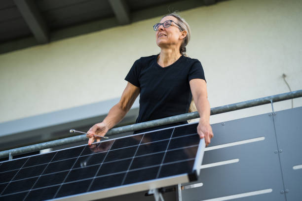 istock woman adjusting solar panel in direction of sunlight 1822884214