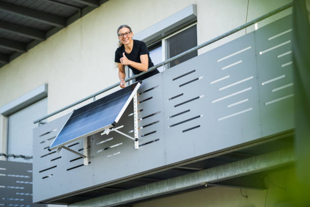 istock woman happy after installing solar panel on balcony 1822884229