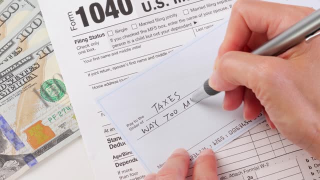Close-up shot of a check being written for taxes
