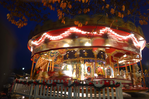 Long exposure shot of a Merry-go-round in a open air Christmas market.