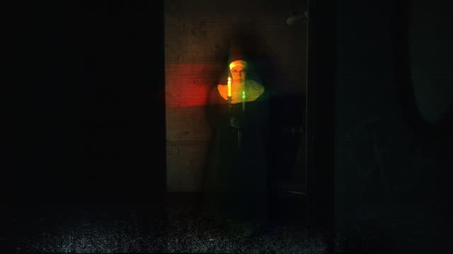 Evil nun materializing with candles in a dark room, old glitchy tv screen effect