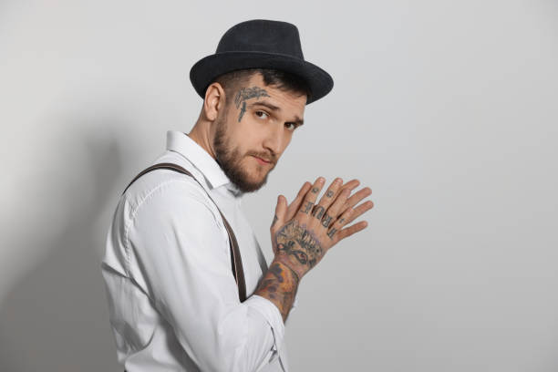 Portrait of handsome hipster man on light grey background. Space for text