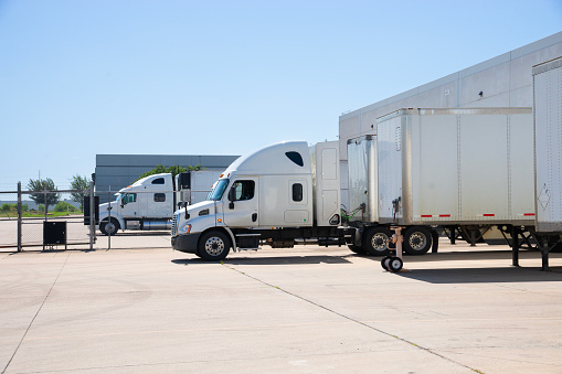 White HGV tractor trailers in a trucking yard