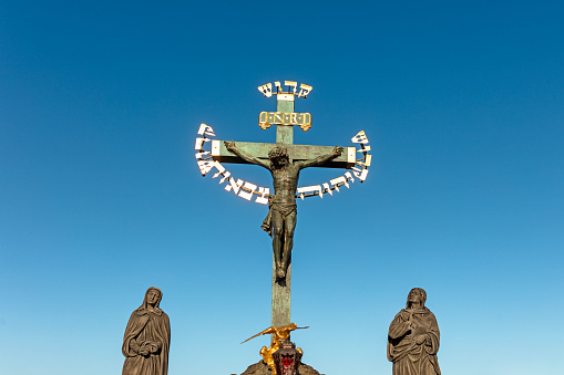 Jesus of Prague, on Charles Bridge in Prague, Czech Republic. The statue features a crucifix surrounded by the Hebrew words \