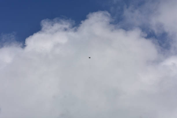 A drone flying in the cloudy sky .