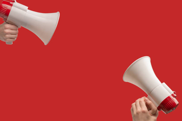 istock Megaphone in woman hands on a red background. 1822941183